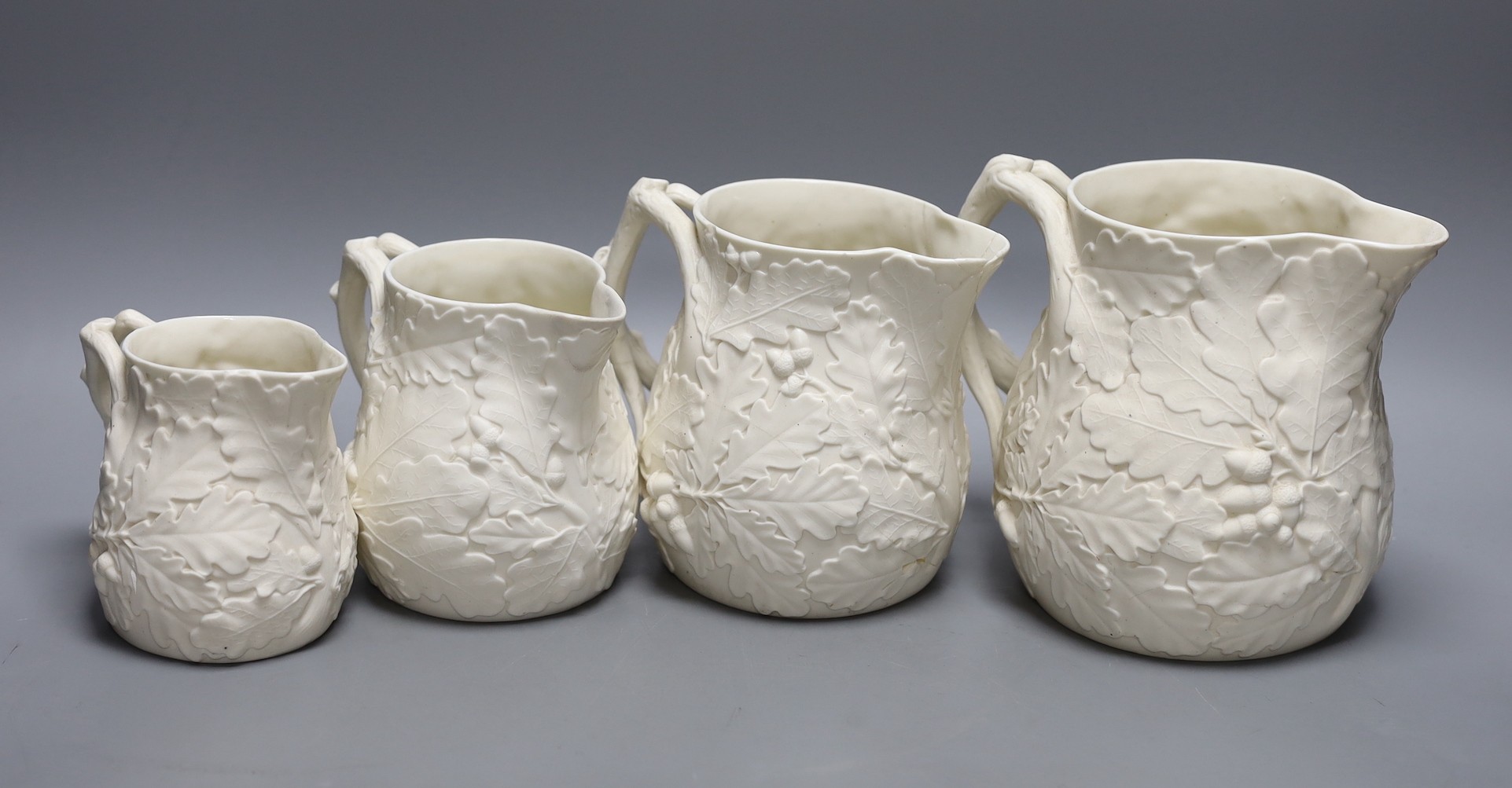 A graduated set of four Victorian parian oak leaf jugs, tallest 15.5cm